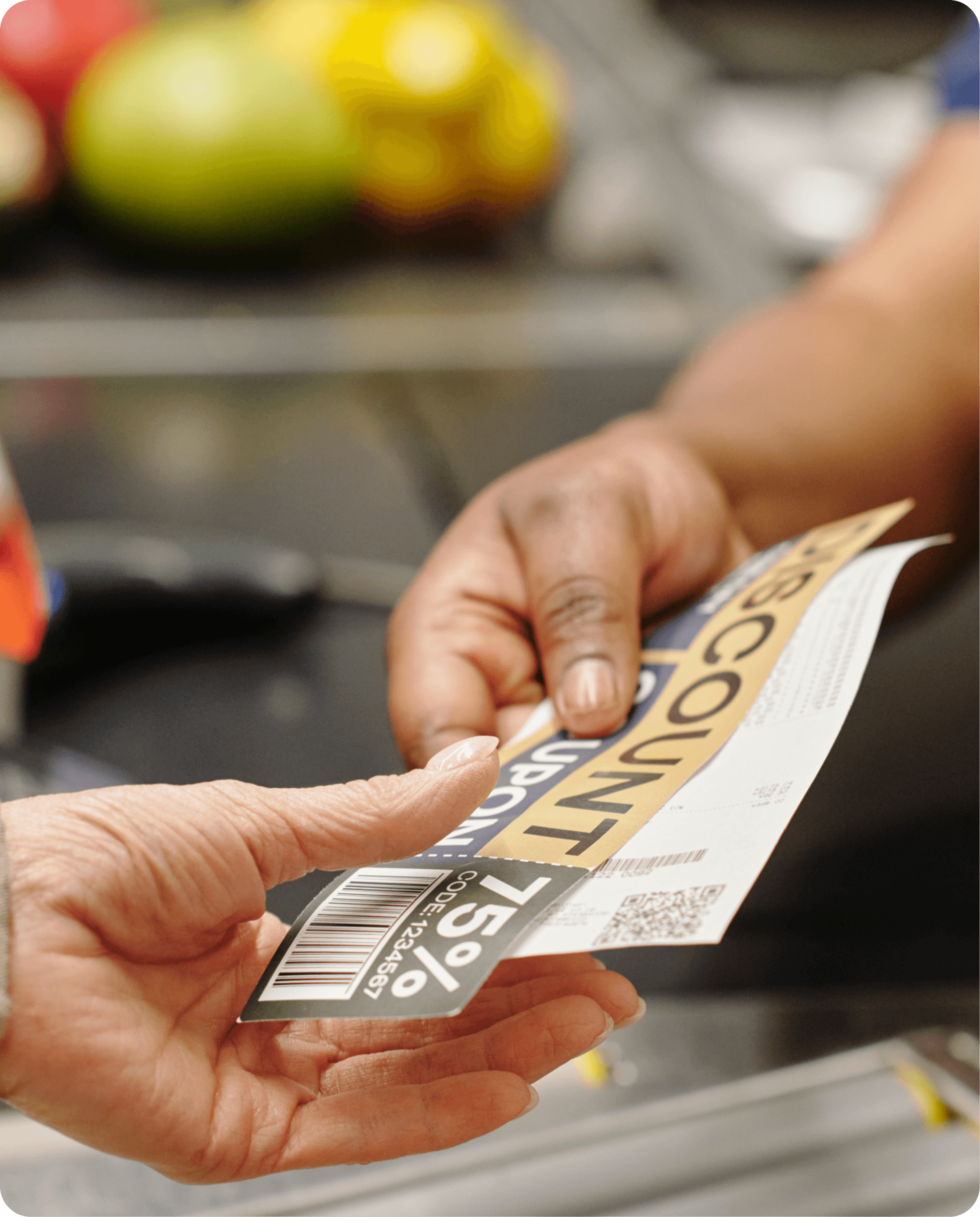 Close-up photo of a woman handing coupons to a cashier